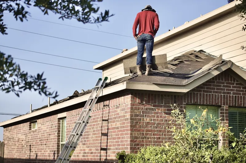 Professional roofer working on a residential roof in West Albany